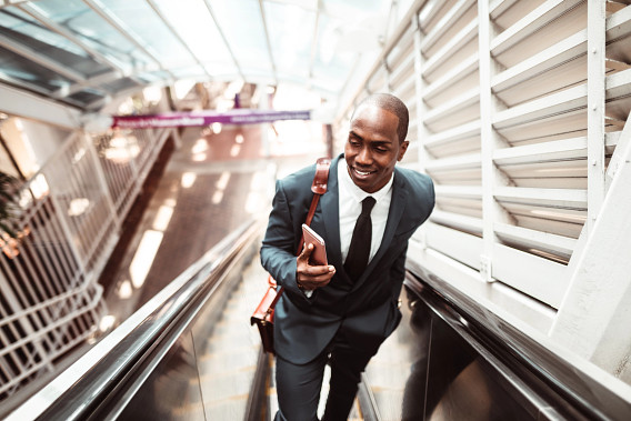 Businessperson in suit on escalator