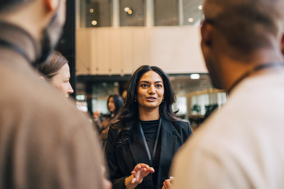 woman talking as colleagues listen