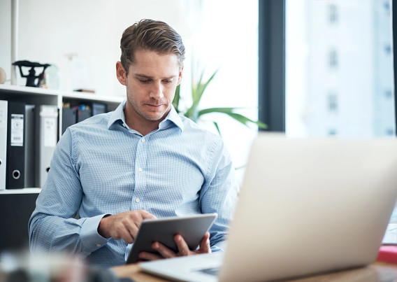 man working on tablet in office