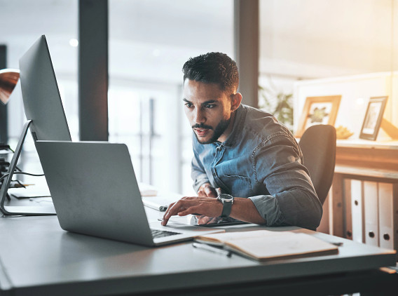 Man studying on laptop at home