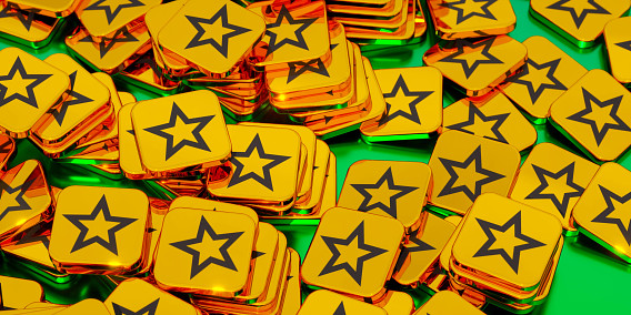 a shiny pile of golden tokens, each with a star on them