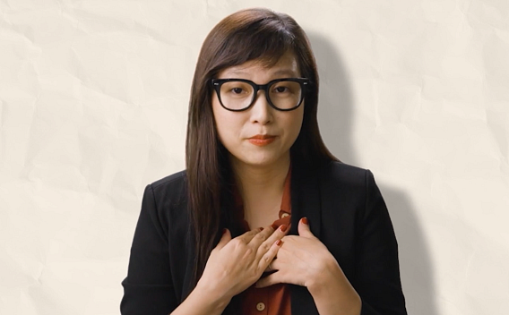 Minh Ngo wearing a red shirt and black jacket